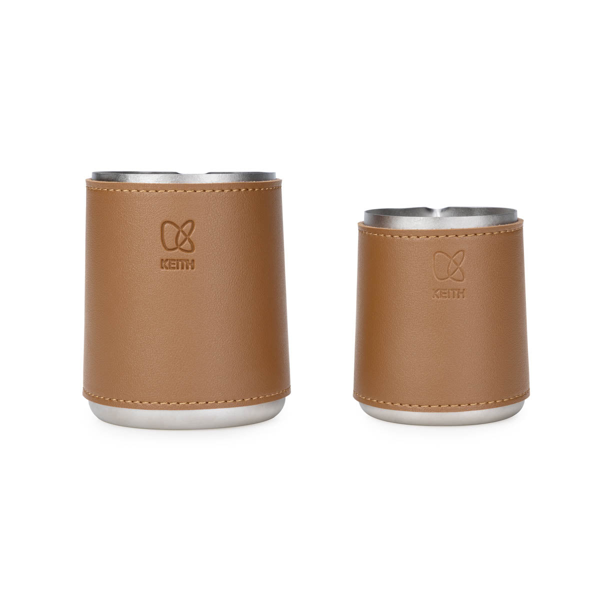 Two Keith Titanium milk pitchers with tan leather sleeves in different sizes on a white background