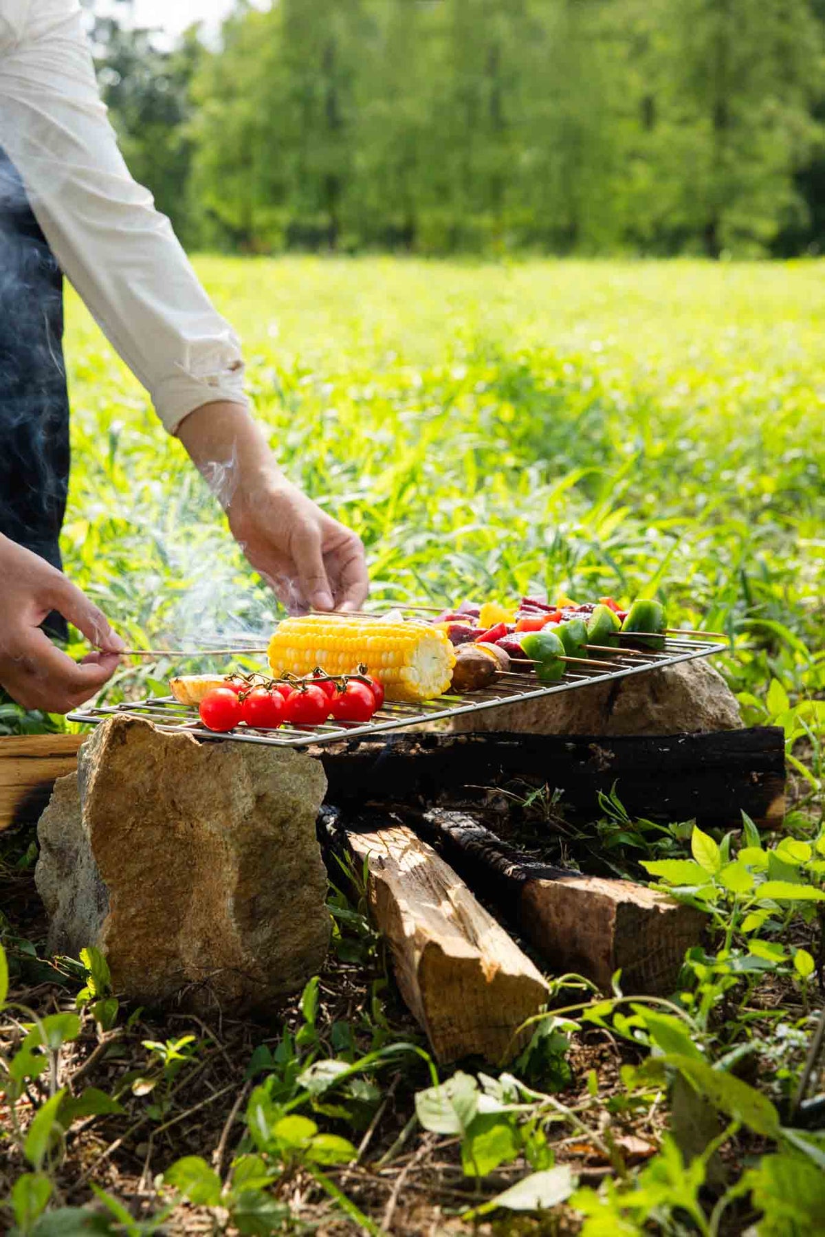 Keith Titanium Ti2211 grill mesh supporting skewers and vegetables over an open campfire