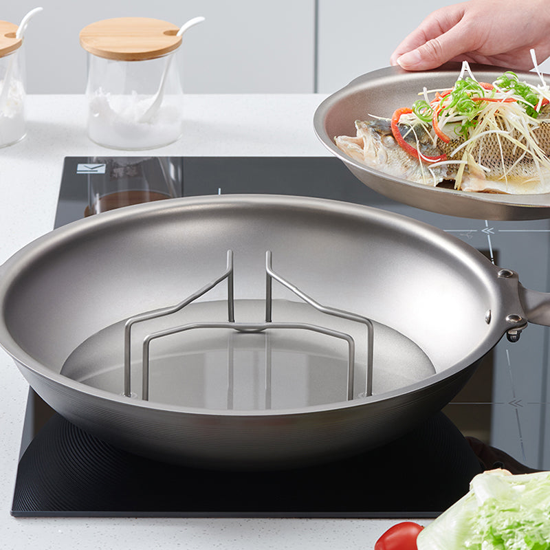 Keith Titanium Ti8732 high tri-leg steaming rack inside a pan on a stovetop