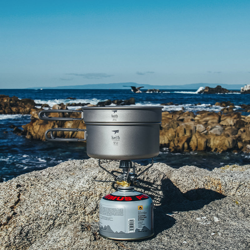 Keith Titanium Ti6017 cook set heating on a camp stove by the ocean