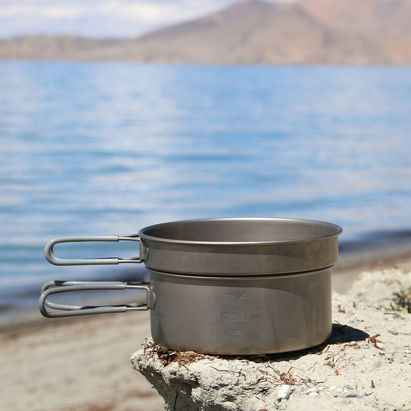 Keith Titanium Ti6017 pot and pan cook set stacked on a rock by the beach