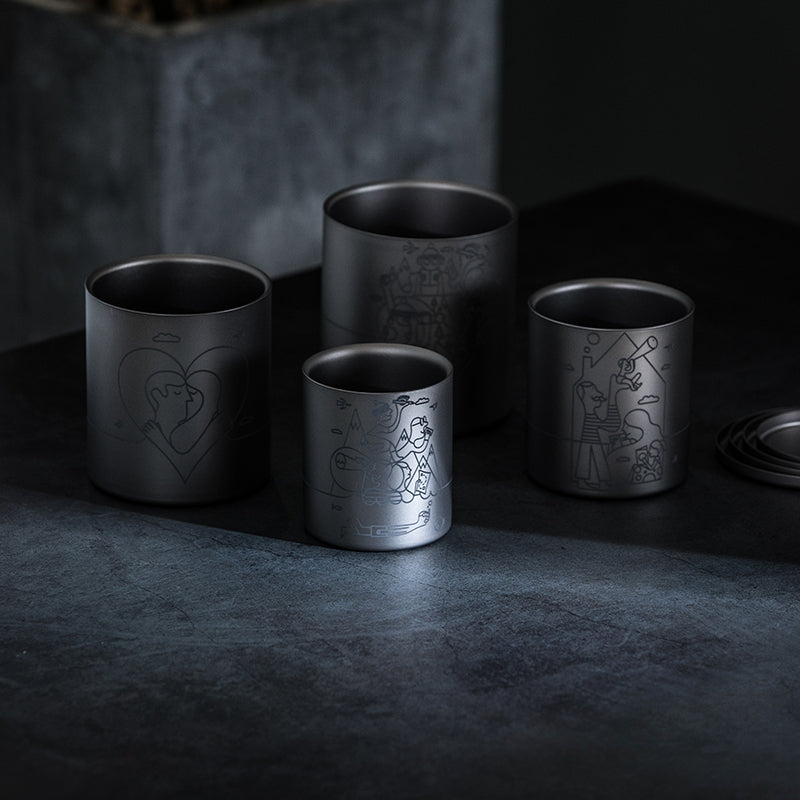 Keith Titanium Jonathan Calugi collectible nesting four-piece mug set on a dark tabletop