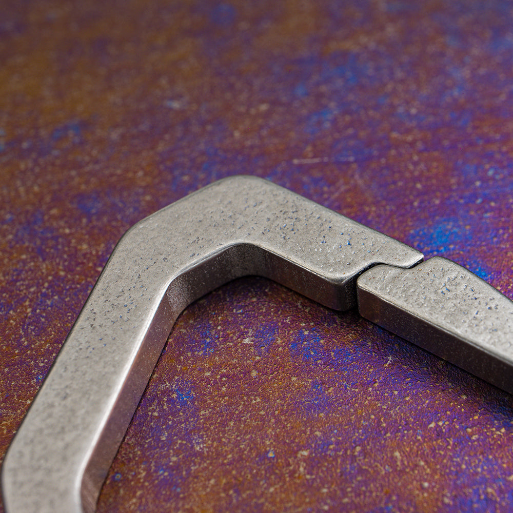 Close-up of the gate hinge on the Keith Titanium Ti1155 carabiner on a textured background