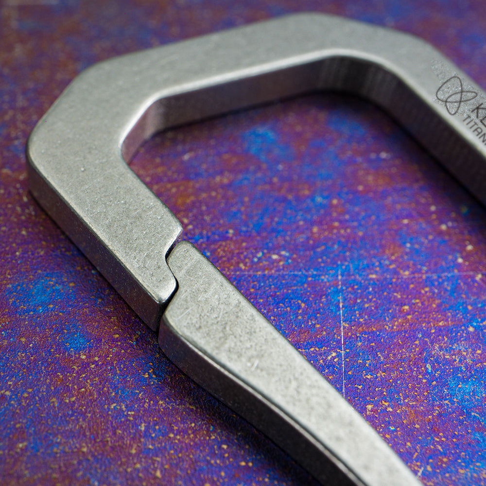 Close-up of the spring gate on the Keith Titanium Ti1155 carabiner on a textured background