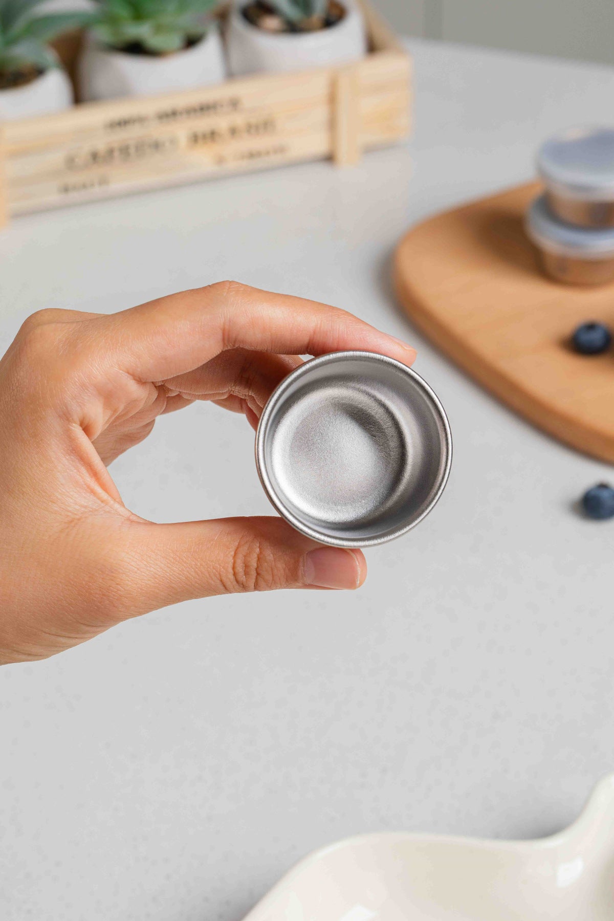 Hand holding an empty Keith Titanium Ti1161 mini container