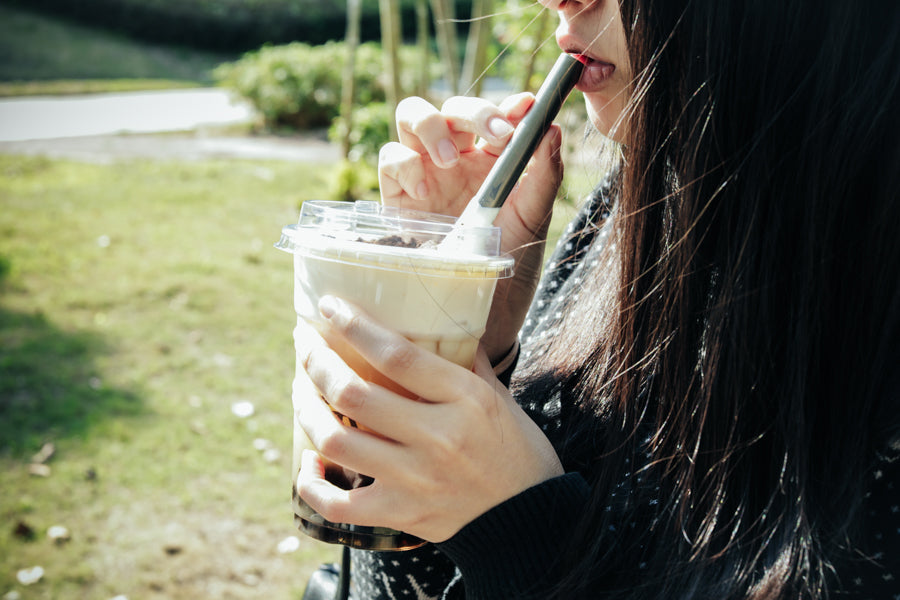 Person drinking through the Keith Titanium Ti3702 straw from a plastic cup outdoors