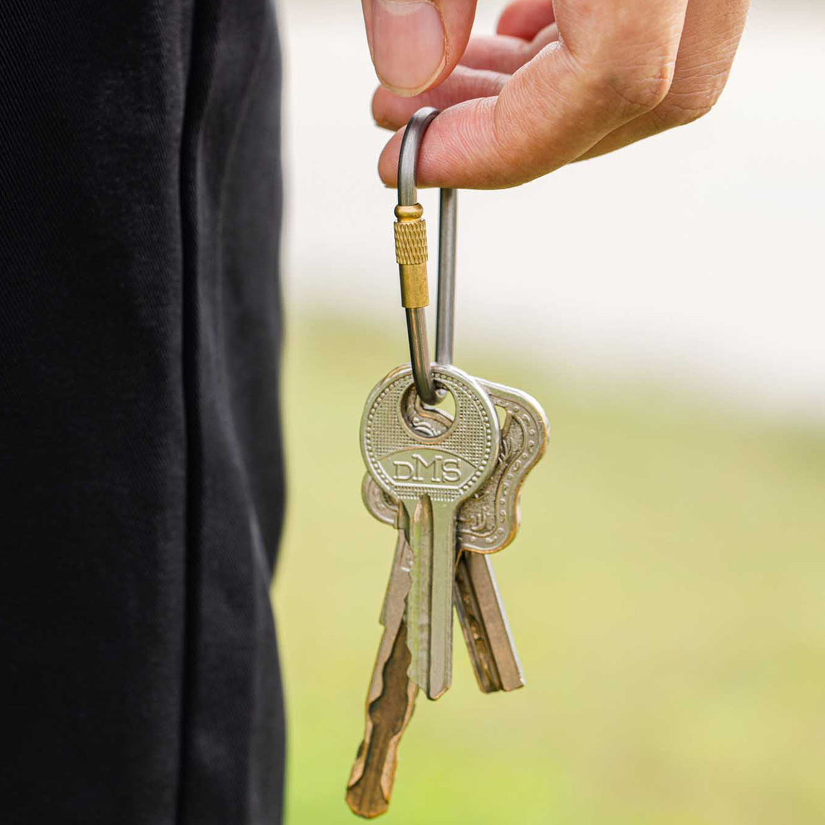 Hand holding keys on the Keith Titanium Ti1150 screw-lock carabiner