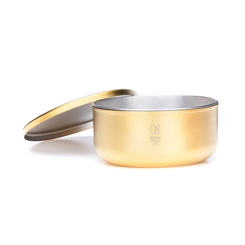Keith Titanium Ti5451 CC lunch box in gilt gold with lid leaned behind the container
