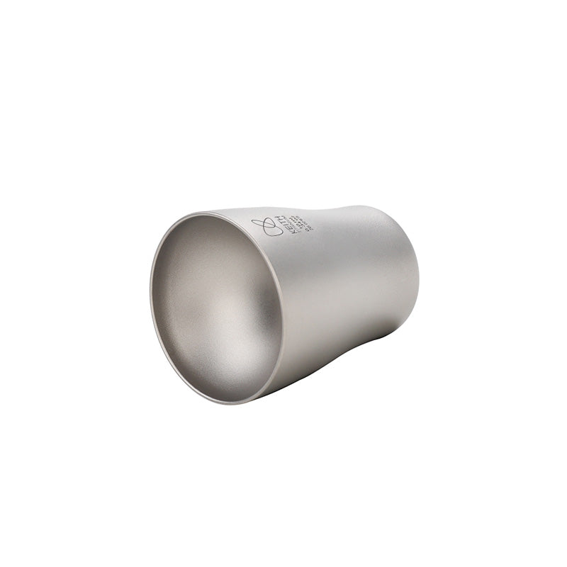 Keith Titanium Ti9304 baijiu shot glass lying on its side on a white background
