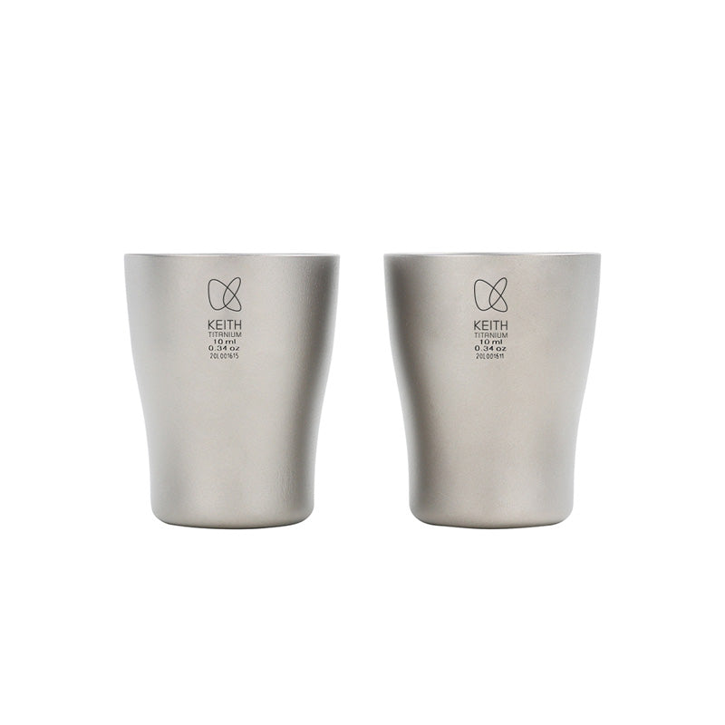 Two Keith Titanium Ti9304 baijiu shot glasses on a white background