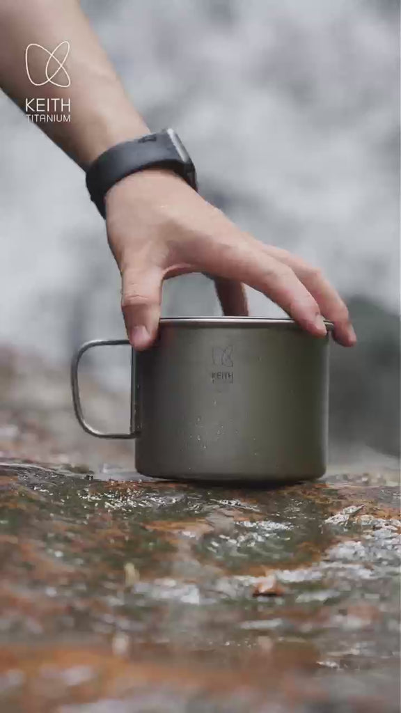 KEITH Ti3209 900ml titanium camping mug with folding handle and lid cooking noodles beside a waterfall
